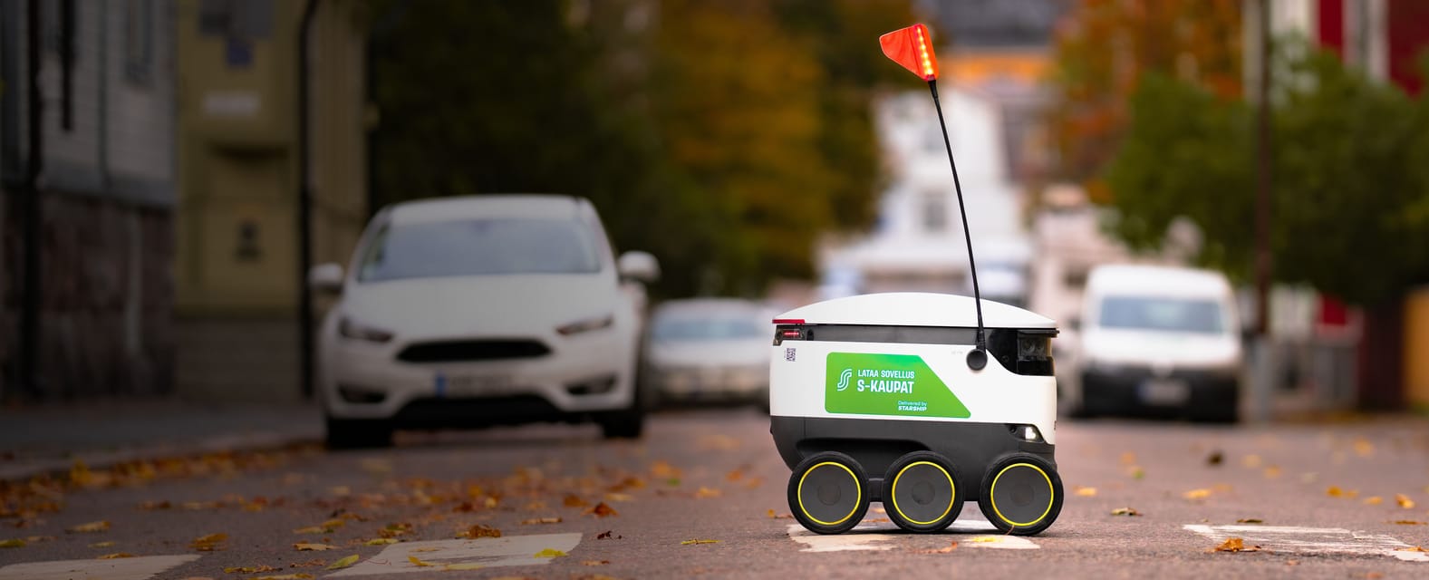 Starship delivery robot crossing a driveway, delivering an S-kaupat grocery order